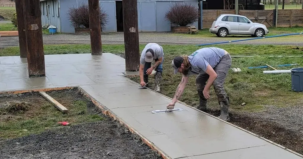 Doyle Construction workers finishing freshly poured concrete