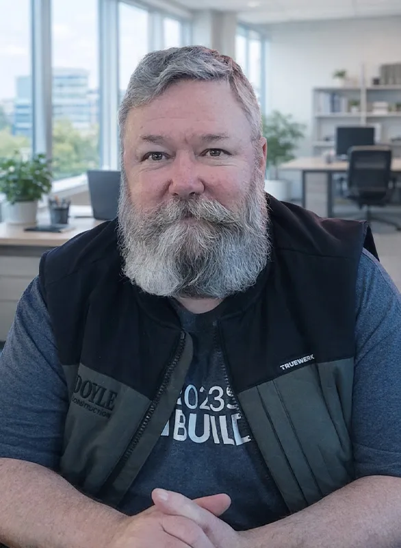 Daimon Doyle of Doyle Construction seated at a desk in the company office