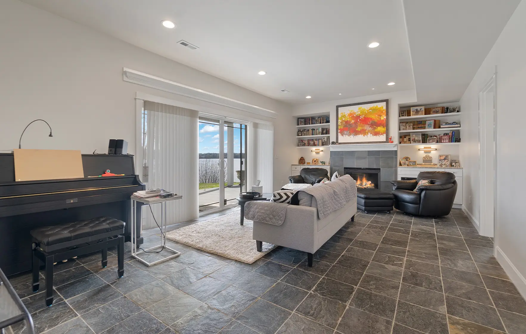 Remodeled living room with slate tile floors, fireplace, and built-in shelving in the Tamoshan home