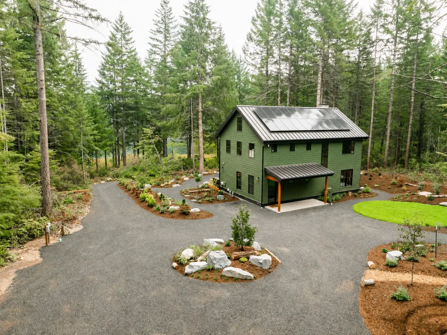 Hatchery Lake Custom Cabin exterior with a metal roof and landscaped gravel drive in the woods