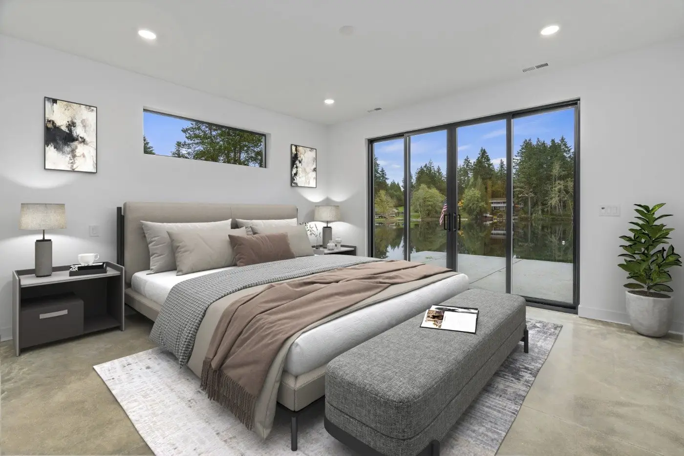 Modern bedroom with large windows and glass doors overlooking a lake and trees, featuring a neatly made bed with neutral bedding, two nightstands with lamps, wall art, a bench, and a potted plant in the corner.